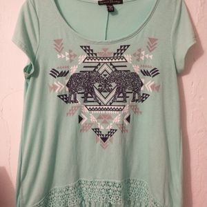 Mint green blouse with an elegant design and fringe.